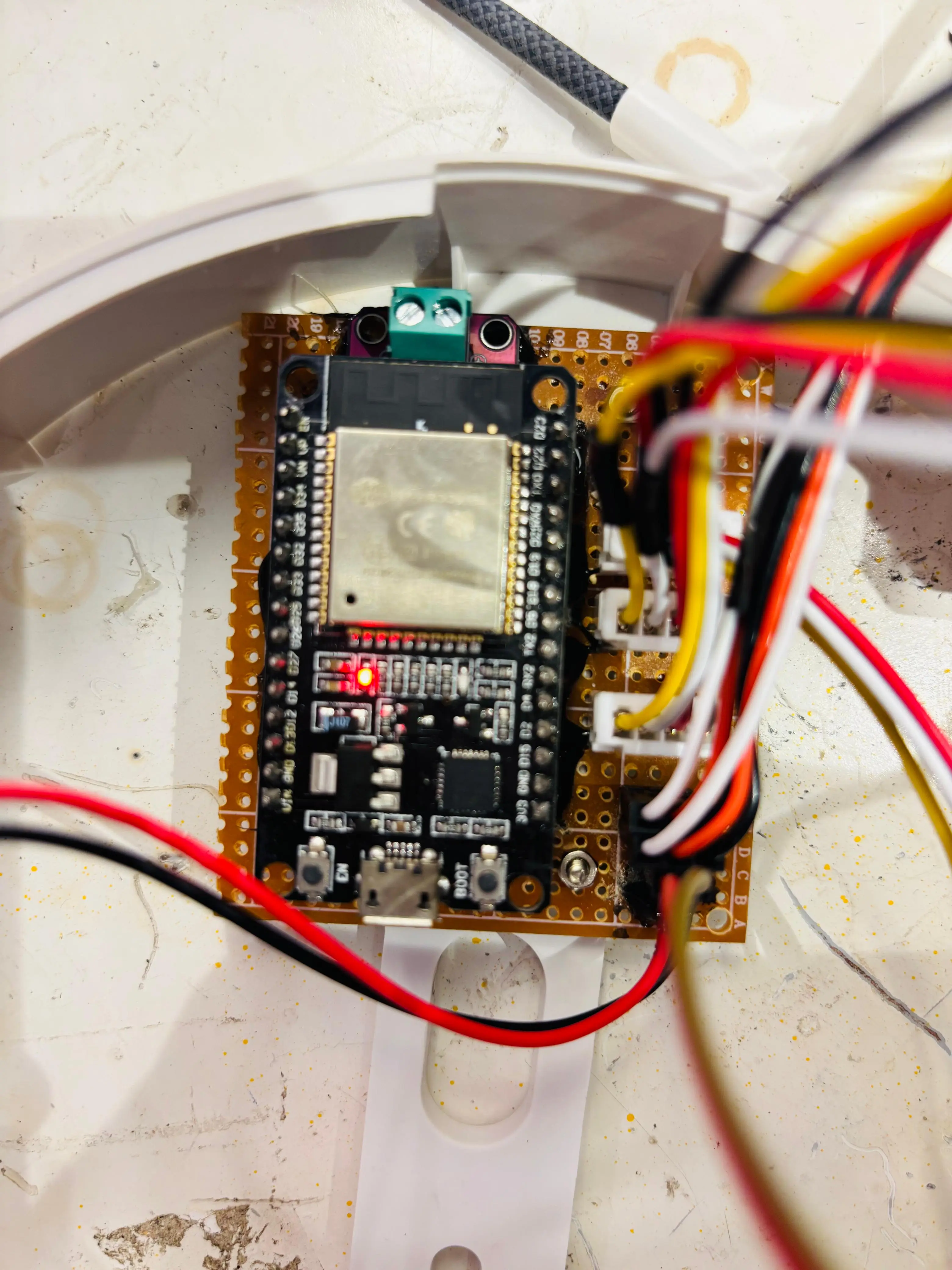 The ESP32 board and wiring inside Lumina's base